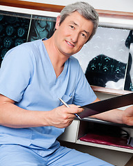 Image showing Medical Professional Holding Clipboard
