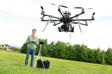 Image showing Technician Flying UAV Octocopter in Park