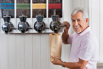 Image showing Senior Man Buying Coffee Beans From Vending Machine