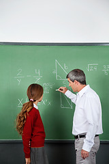 Image showing Teacher and student at blackboard