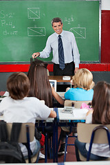 Image showing Teacher Looking At Students In Classroom