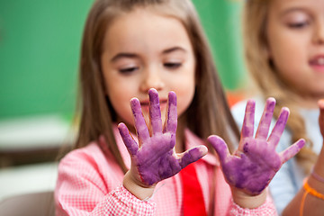 Image showing Girl Looking At Colored Hands In Art Class