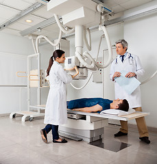 Image showing Radiologists With Patient In X-ray Room