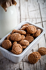 Image showing meringue almond cookies in a bowl and bottle of milk