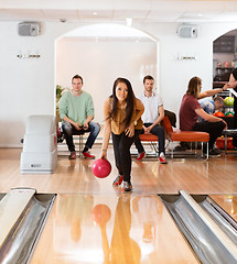 Image showing Woman Throwing Bowling Ball in Club