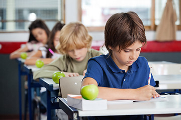 Image showing Boy Studying At Desk In Classroom
