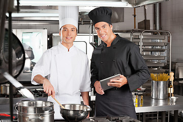 Image showing Happy Chefs With Digital Tablet Cooking Food