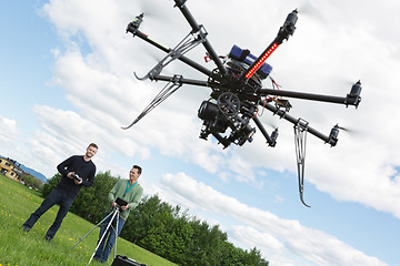 Image showing Male Engineers Operating UAV Helicopter