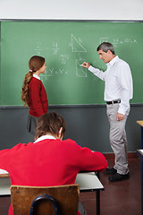 Image showing Male Teacher Teaching Geometry To Girl In Classroom