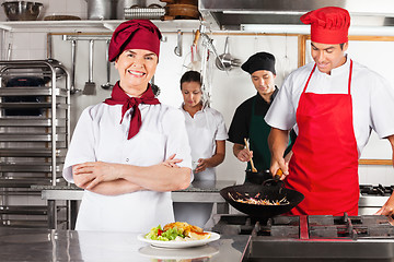 Image showing Female Chef With Arms Crossed In Kitchen