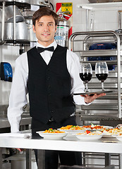 Image showing Waiter Holding Wineglasses on Tray