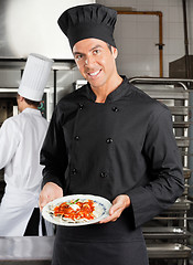 Image showing Chef Presenting Dish In Kitchen