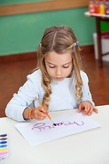 Image showing Girl Painting Name On Paper At Desk