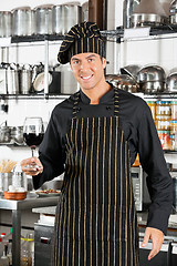 Image showing Happy Chef Holding Glass Of Red Wine