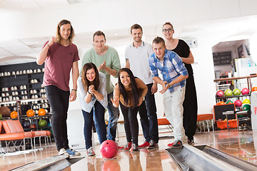 Image showing Woman Bowling While Friends Cheering in Club