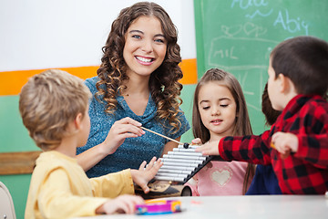 Image showing Teacher And Children Playing With Xylophone In Classroom