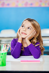 Image showing Girl Looking Up While Sitting With Head In Hands In Class