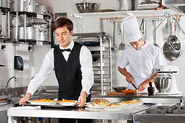 Image showing Waiter And Chef Working In Kitchen