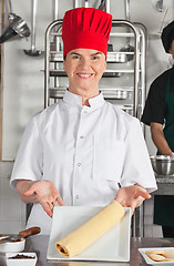 Image showing Female Chef Presenting Chocolate Roll