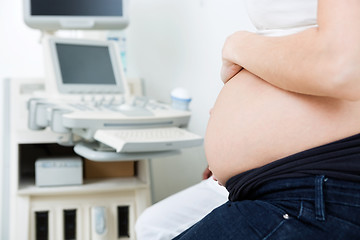 Image showing Pregnant Woman With Ultrasound Machine In Background