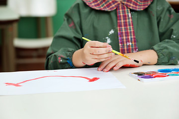 Image showing Midsection Of Boy Painting At Desk