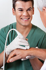 Image showing Technician Scanning Male Patient's Hand