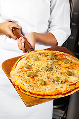 Image showing Female Chef Holding Pizza On Shovel