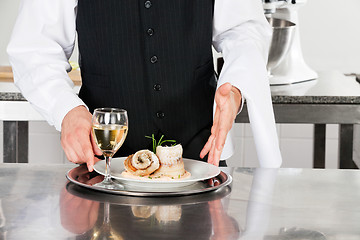 Image showing Waiter With Salmon Roll And White Wine