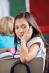 Image showing Schoolgirl Leaning On Chair In Classroom