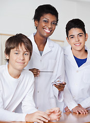 Image showing Portrait Of Female Teacher With Male Students Experimenting