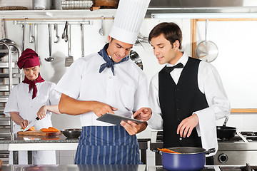 Image showing Waiter And Chef Using Digital Tablet In Kitchen