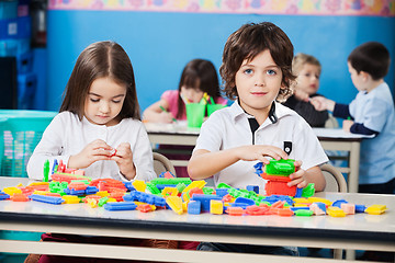 Image showing Boy With Female Friend Playing Blocks In Kindergarten