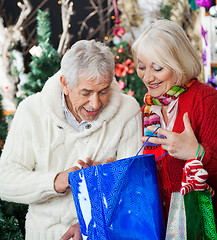 Image showing Surprised Couple Looking Into Shopping Bag