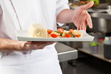 Image showing Chef Presenting Dish In Kitchen