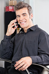 Image showing Male Customer Using Cellphone At Salon