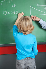 Image showing Little Boy Writing Formula On Greenboard