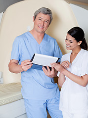 Image showing Technicians Standing By MRI Scan Machine