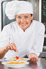 Image showing Happy Chef Adding Spices To Food