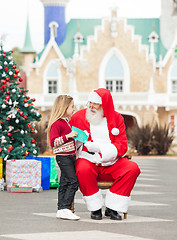 Image showing Girl Giving Wish List To Santa Claus