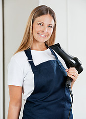 Image showing Female Hairstylist Holding Hairdryer