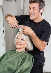 Image showing Hairstylist Cutting Client's Hair In Parlor