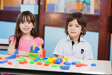 Image showing Cute Friends With Construction Blocks In Kindergarten