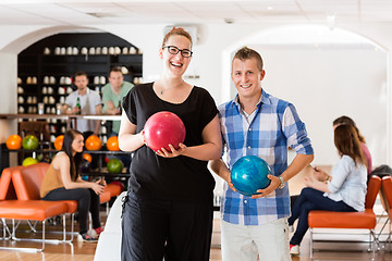 Image showing Happy Man And Woman Holding Bowling Balls in Club