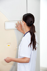 Image showing Female Doctor Operating CT Scan Machine