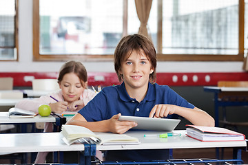 Image showing Schoolboy Using Digital Tablet In Classroom