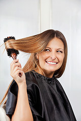 Image showing Woman Brushing Hair In Salon
