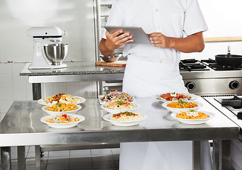 Image showing Chef Using Digital Computer In Kitchen