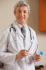 Image showing Doctor Holding Glasses And Medicine Box