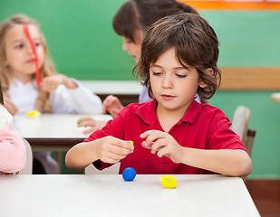 Image showing Boy Molding Clay At Classroom