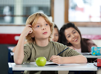 Image showing Thoughtful Schoolboy Scratching Head